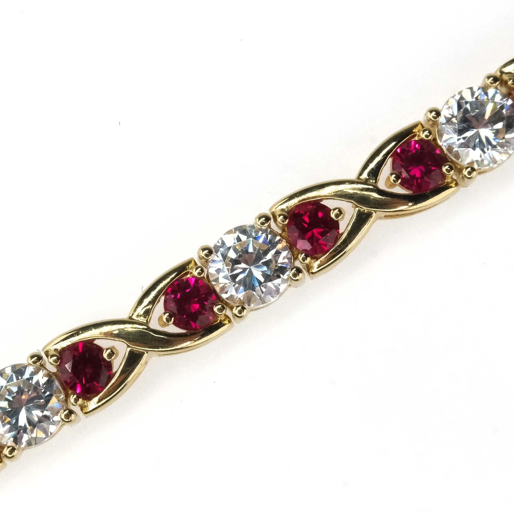 Cubic Zirconia and Red Spinel "X"Link Tennis Bracelet is 14K Yellow Gold