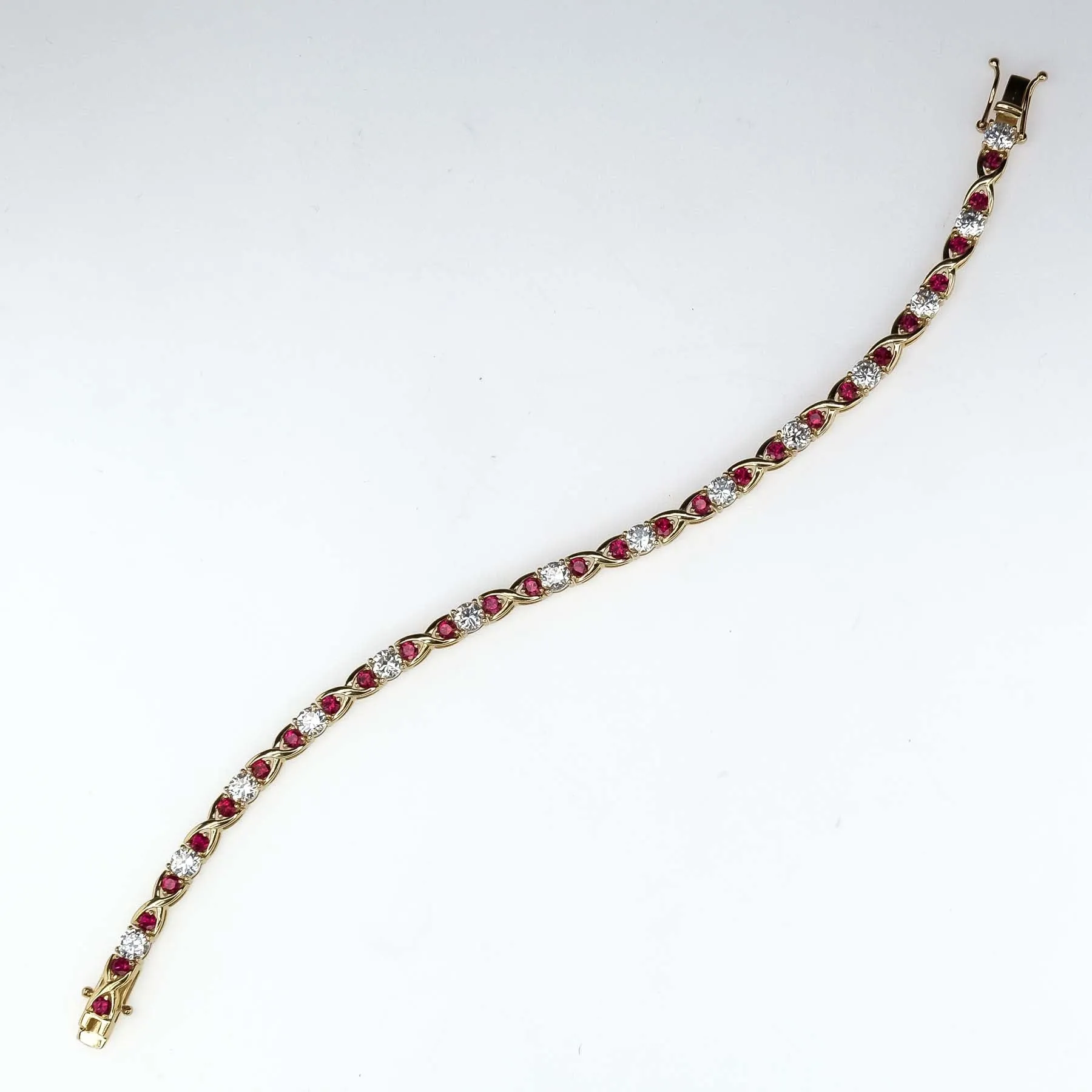 Cubic Zirconia and Red Spinel "X"Link Tennis Bracelet is 14K Yellow Gold