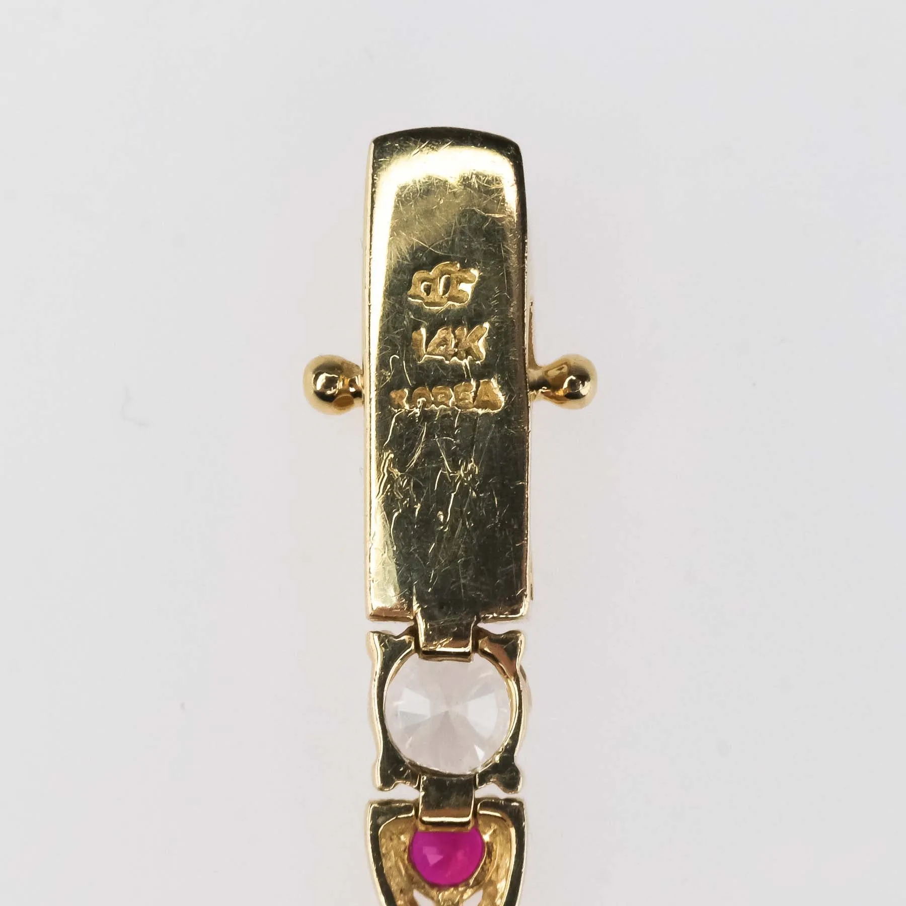 Cubic Zirconia and Red Spinel "X"Link Tennis Bracelet is 14K Yellow Gold