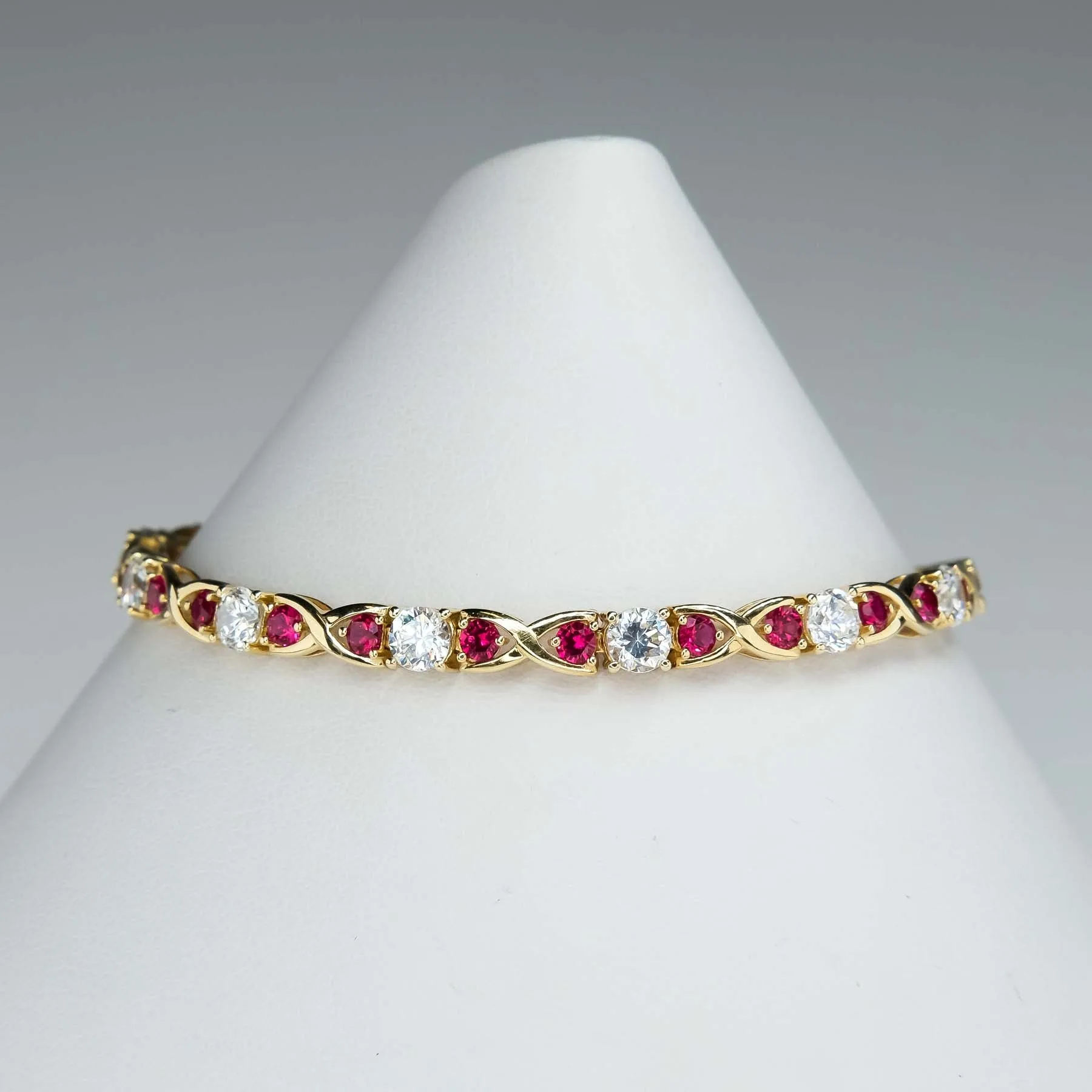 Cubic Zirconia and Red Spinel "X"Link Tennis Bracelet is 14K Yellow Gold