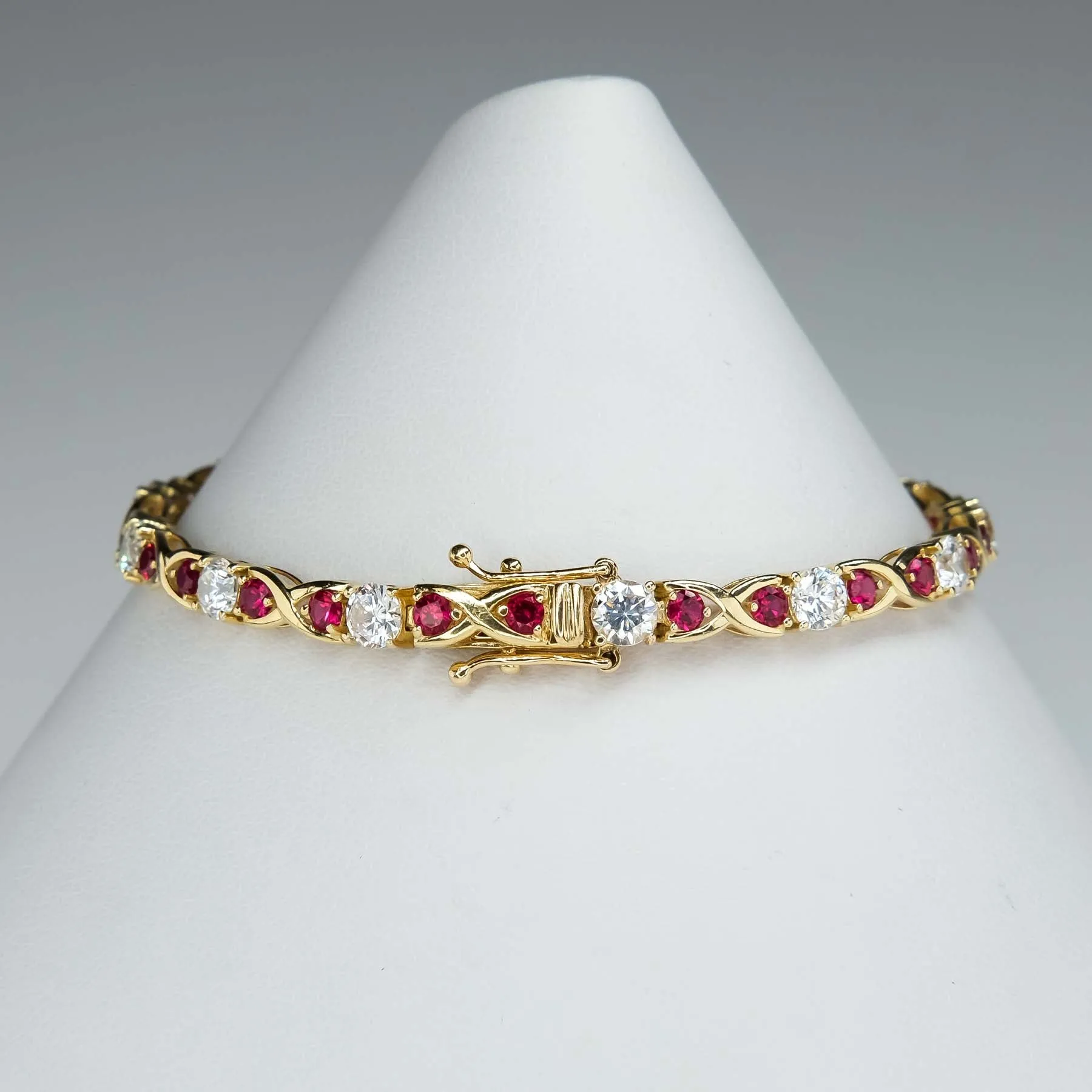 Cubic Zirconia and Red Spinel "X"Link Tennis Bracelet is 14K Yellow Gold